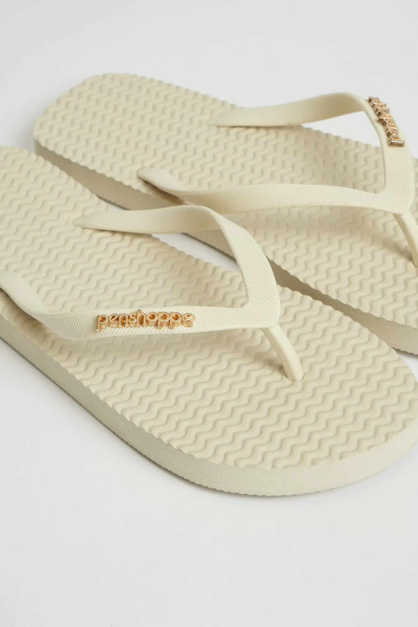 Women's Textured Sole Flip Flops with Metal Branding